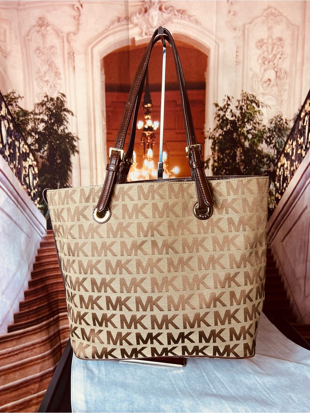 Michael Kors Jet Set tote features monogram canvas, contrasting leather straps